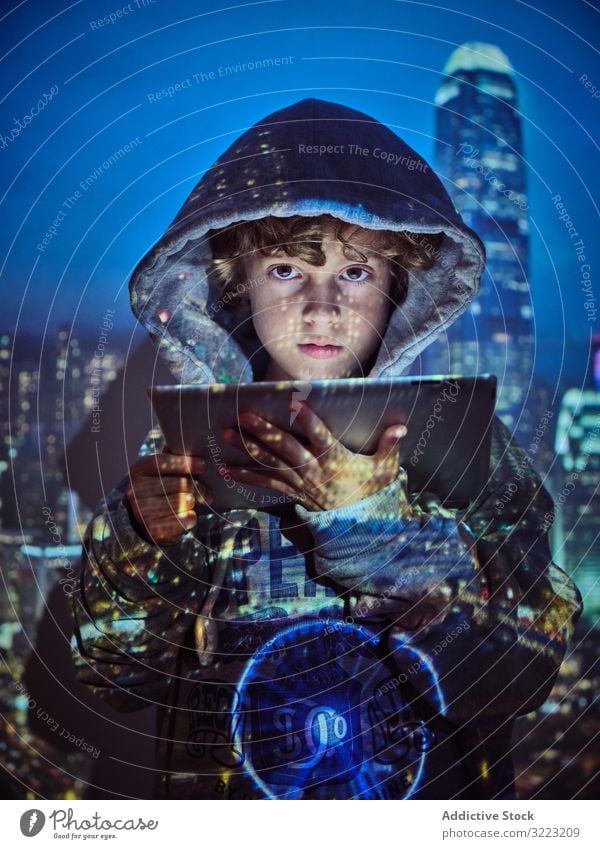 Hacker boy using tablet hacker code database little programmer virus digital password software kid child device gadget browsing hoodie scam website symbol glow