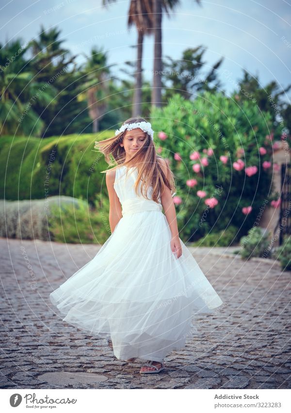 Adorable little girl in airy dress dancing in park child spinning leisure enjoyment happy sweet kid adorable female cute beautiful innocence purity