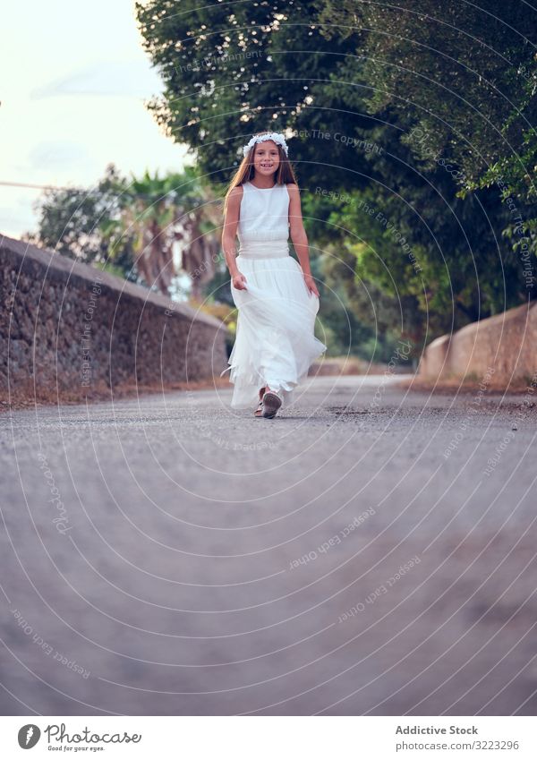 Adorable little girl in airy dress walking in park child running leisure enjoyment happy sweet kid adorable female cute beautiful innocence purity individuality