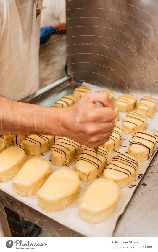 Crop confectioner decorating pastry with chocolate cream bakery squeeze glaze fresh quality preparation small business food work cake traditional occupation