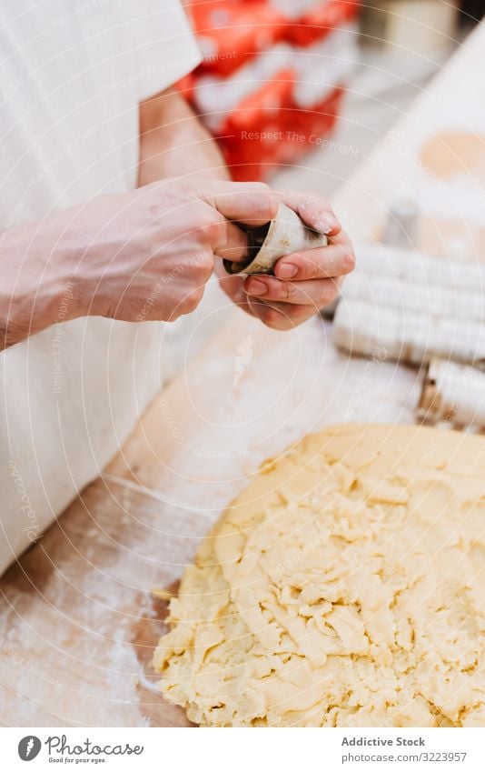 Unrecognizable cook putting pastry dough in cup confectioner bakery table kitchen preparation fresh man raw cuisine professional food chef restaurant cafe flour