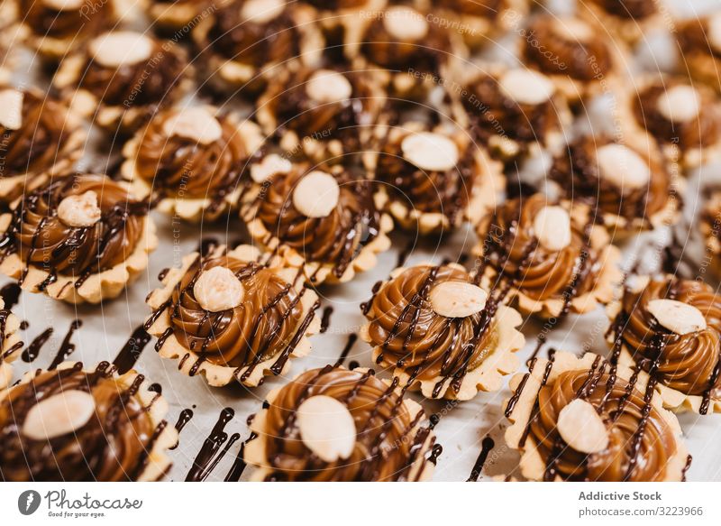 Delicious desserts with nuts and caramel chocolate cream sauce tart food sweet ingredient syrup pastry meal bakery paper parchment set many delicious tasty