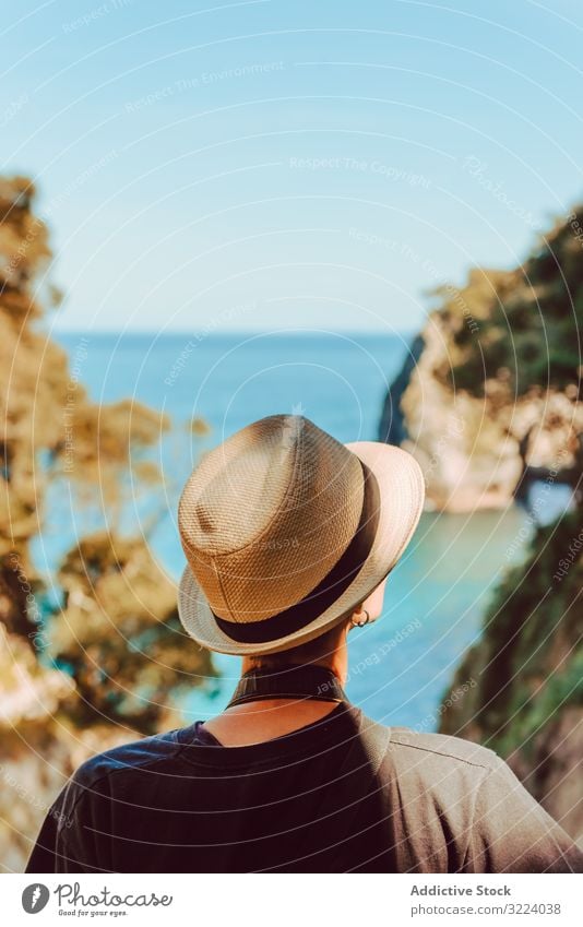 Female tourist contemplating picturesque landscape woman travel sea rock ribadedeva asturias spain trip vacation destination female casual hat stand enjoy