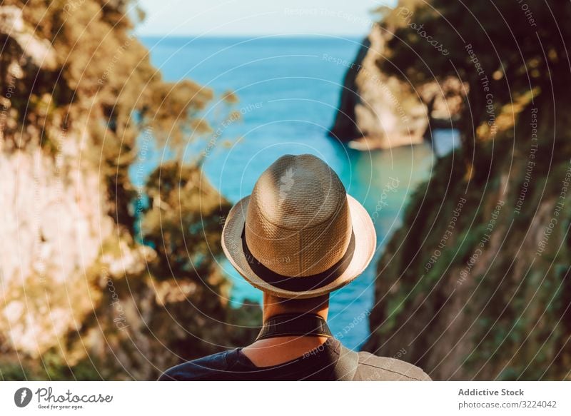 Female tourist contemplating picturesque landscape woman travel sea rock ribadedeva asturias spain trip vacation destination female casual hat stand enjoy