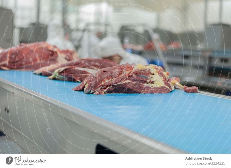 Chopped pieces of raw meat on table industrial conveyor slaughterhouse cut food uncooked fresh slice preparation butchery carcass cutting nutrition ingredient