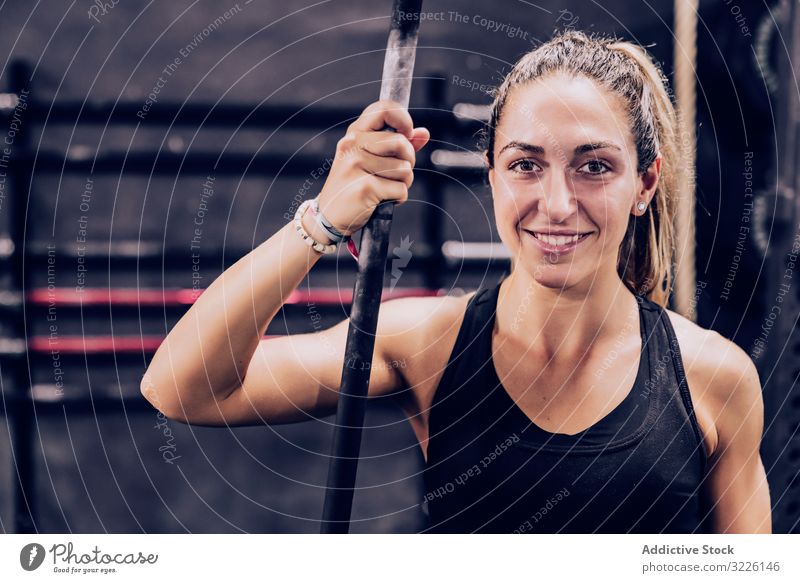 Serene woman relaxing in gym rest pole bar fitness center slender female serene peaceful lifestyle training sport healthy workout sportswear athlete break