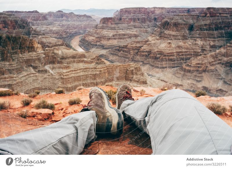 Exhausted male having break on deserted rock man canyon cliff tired exhausted recreate edge scenic usa nature hiker vacation rest relax travel landscape walk