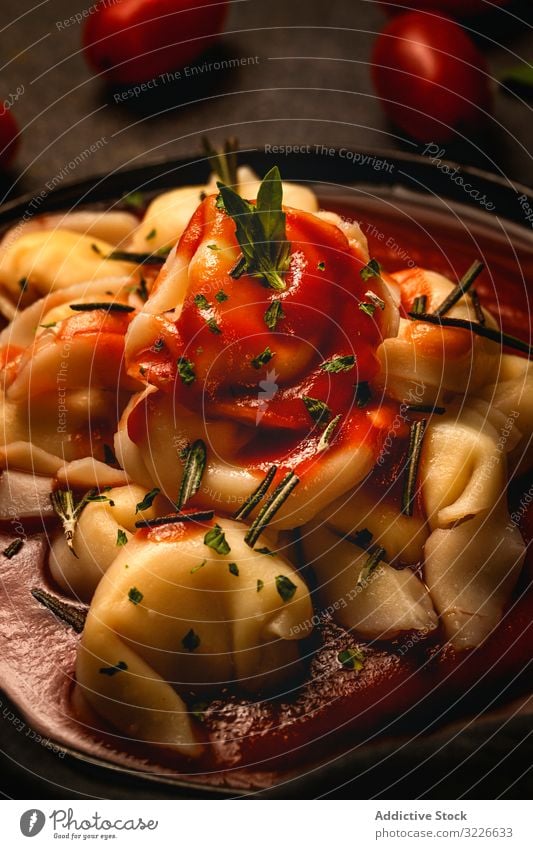 Plate of delicious ravioli with tomato sauce served on table plate italian cooked herb gourmet fork exquisite napkin rosemary tasty ketchup meal food dish