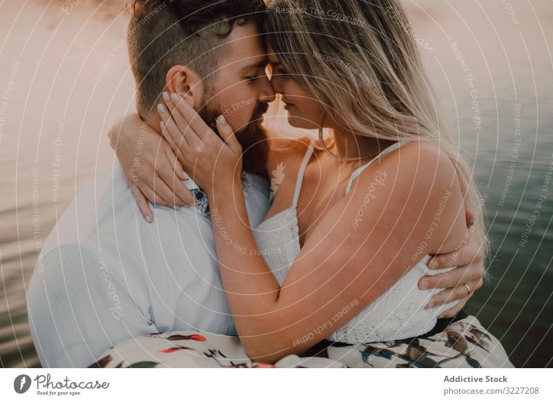 Loving couple standing ankle deep in water on beach hug love lake tender shore adorable embrace coast vacation nature honeymoon caress together affection