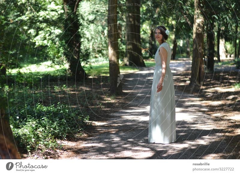 young woman in elegant white dress on path under trees Woman Elegant off Dress White Look back Looking into the camera eye contact Feminine Park Forest Adults