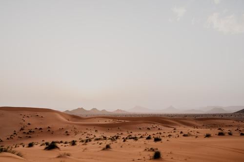 Sunset sky over hills in desert sunset sand cloudy rock arid morocco africa evening nobody landscape nature dune stone boulder sundown dusk twilight drought dry