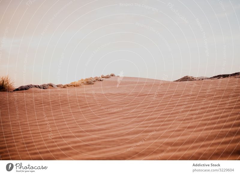 Sunset sky over hills in desert sunset sand cloudy rock arid morocco africa evening nobody landscape nature dune stone boulder sundown dusk twilight drought dry