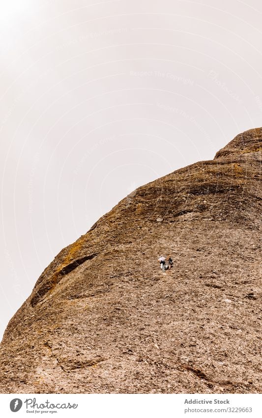 Climbers climbing the mountain of Montserrat, wild danger safety dangerous rocky trekking summer hiker extreme active hiking vertical adventure activity tourist