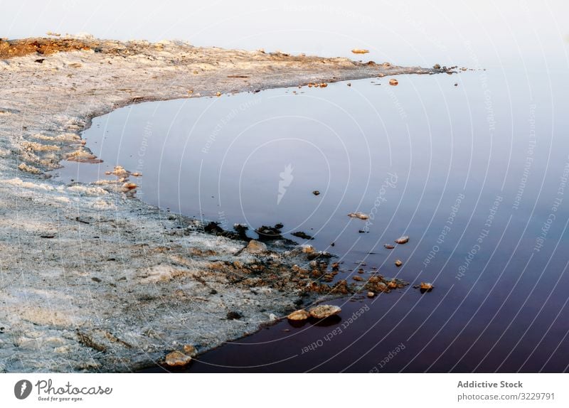 Beautiful lake with rocks in blue water landscape still natural beauty lagoon reflection travel destination tourism trip stone journey shore calm tranquil