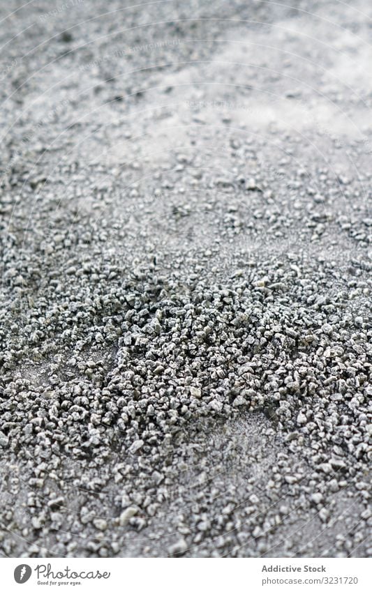 Pile of frosted pebble on ground pile texture small frozen rock grey icy snow natural abstract cobble dark boulder gravel material heap winter background