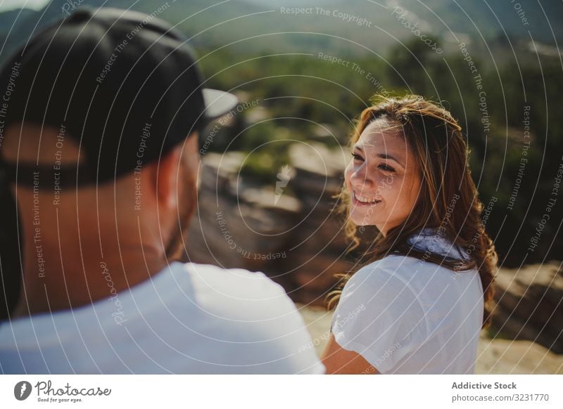 Happy couple sitting at mountain cliff happy freedom romantic relaxed enjoying edge height matching identical young adult recreation love lifestyle adventure