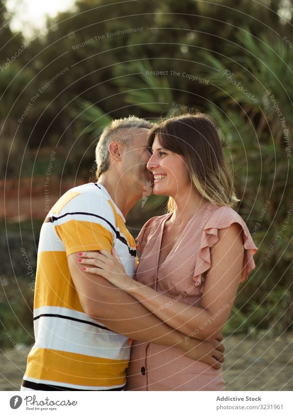 Happy couple looking at each other love smile happy vacation sunny daytime man woman adult honeymoon summer nature shore coast relationship holiday tropical