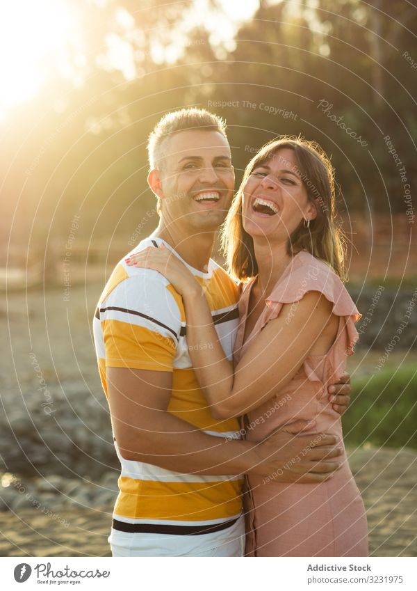 Couple looking al camera with happy smile couple love vacation sunny daytime man woman adult honeymoon summer nature shore coast relationship holiday tropical