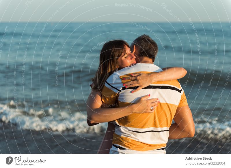 Adult couple embracing near sea beach resort love hug date smile happy vacation man woman adult honeymoon summer shore coast relationship water embrace ocean