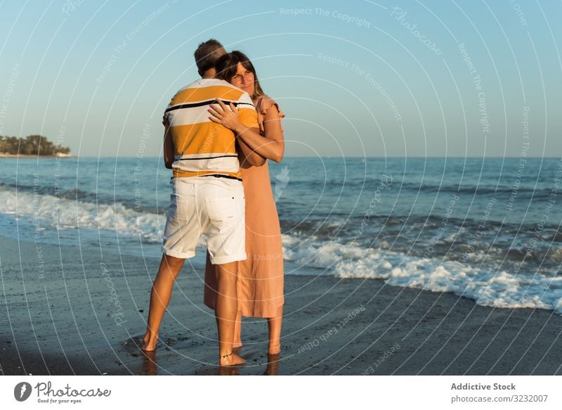 Adult couple embracing near sea beach resort love hug date smile happy vacation man woman adult honeymoon summer shore coast relationship water embrace ocean