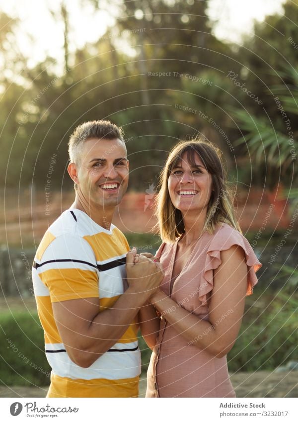 Happy couple looking at each other on beach resort love smile happy holding hands vacation sunny daytime man woman adult honeymoon summer nature shore coast