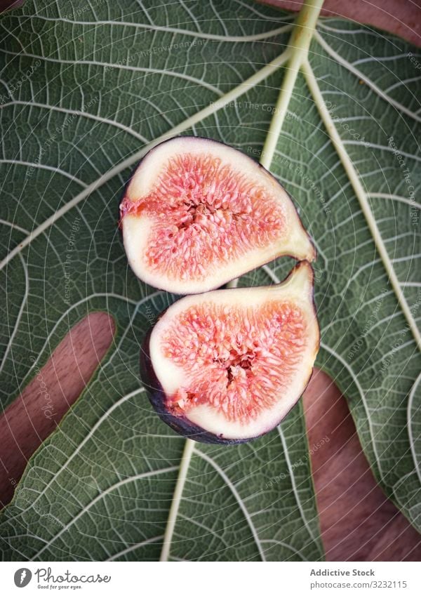 pieces of fig over table and green leaves leaf mature rustic fresh fruits rural tree food wooden traditional closeup spain home edible figs ripe bright