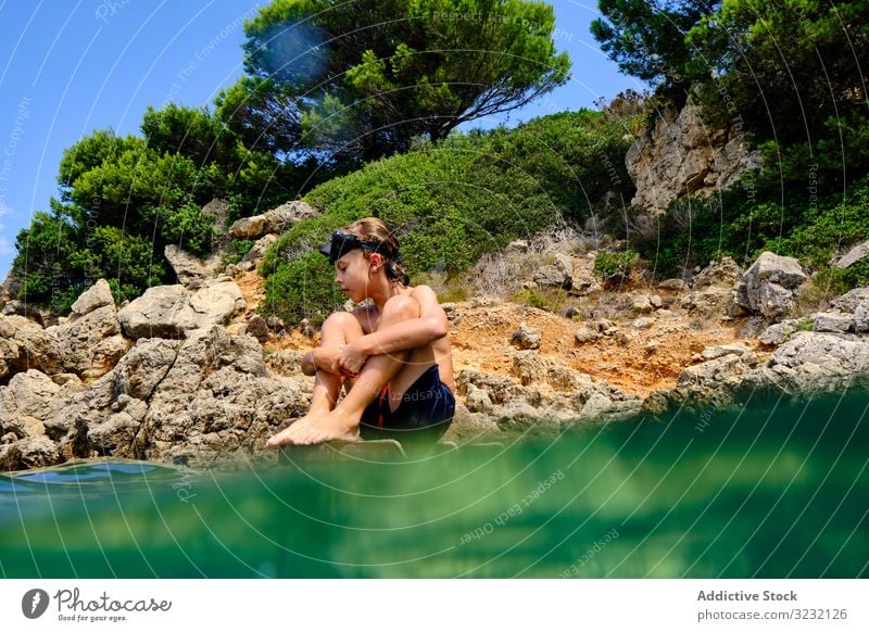 Little boy getting ready to jump in water sea dive summer seashore balance child mask coast travel active rocky tourism cliff sporty recreation wet energy