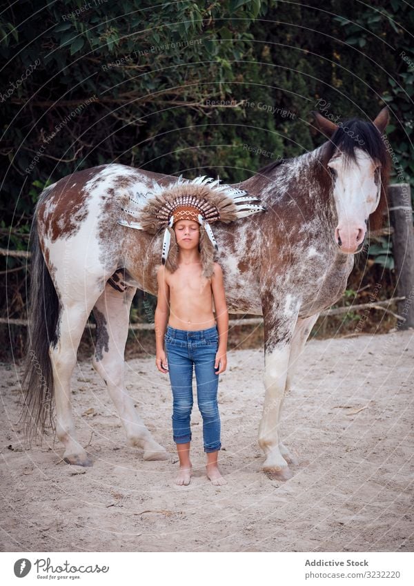 Pensive kid embracing horse boy embrace harmony war bonnet authentic indian horseback love kind bonding farm costume daydream meditation child innocence