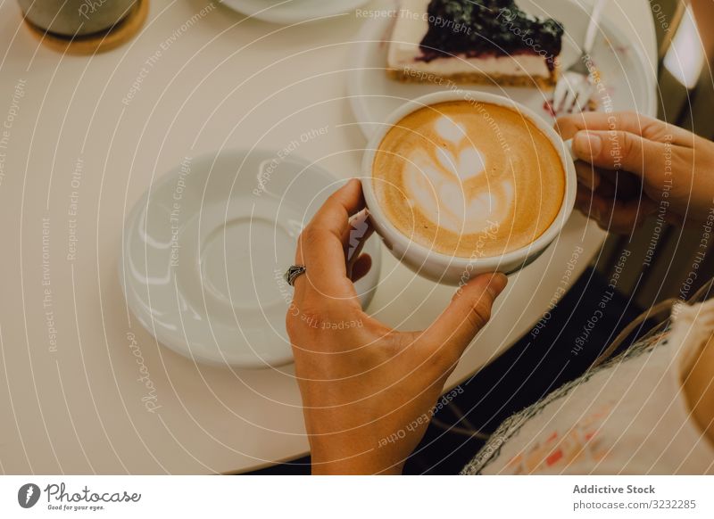 Anonymous woman drinking coffee in cafe first person view anonymous positive happy sip mug modern pleased cheerful coffee shop playful young adult hot drink