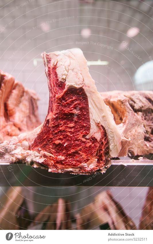 Raw meat on a butcher's chiller for maturing t-bone steak madure loin aged butchery cut fresh beefsteak uncooked protein cow fillet tenderloin food raw sirloin