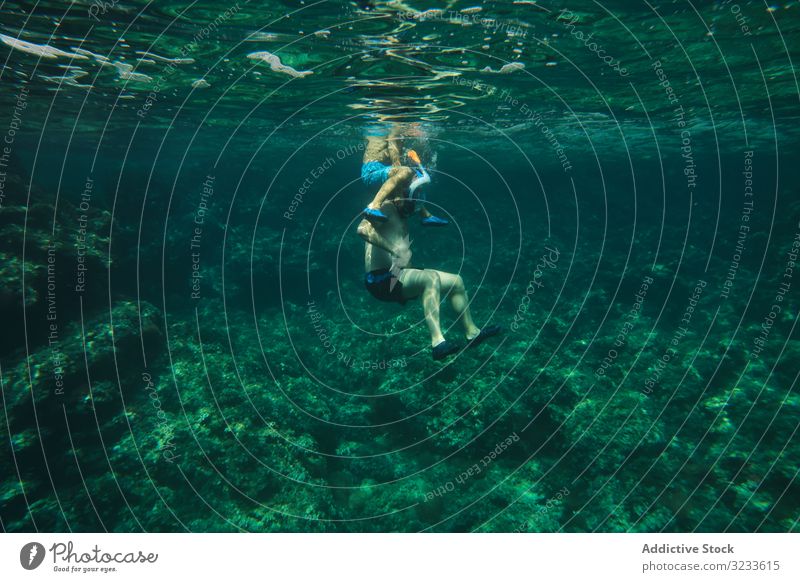 Male swimmer floating among sea waves boy underwater tranquil active surface training calm sport athlete person silent peace harmony energy guy leisure effort