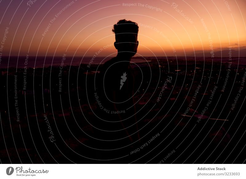 Silhouette of male enjoying picturesque sunset man silhouette sky landscape dusk majestic breathtaking romantic carefree colorful bright purple orange violet