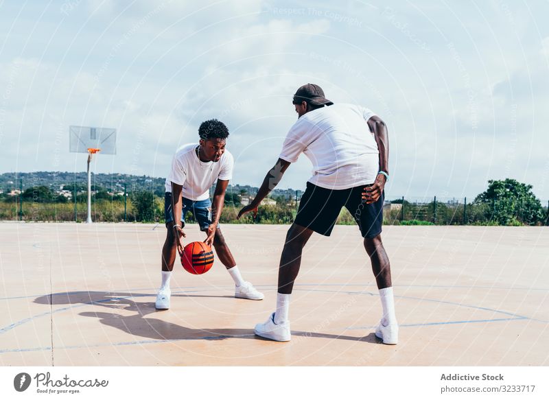 African American guys playing basketball in bright day sportsmen training player activity athlete skill action black african american court athletic