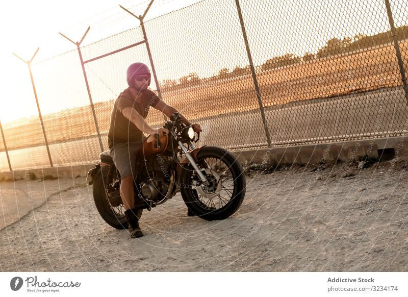 Strong man driving motorcycle drive road sunglasses serious strong male beard ride deserted transport bike biker freedom travel engine power transportation