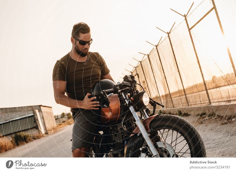 Strong man driving motorcycle drive road sunglasses serious strong male beard ride deserted transport bike biker freedom travel engine power transportation