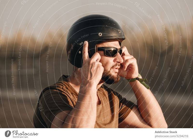 Pensive male in helmet man brutal beard sunglasses pensive biker travel ride motor style racer motorcyclist transport drive road motorcycle vehicle motorbike