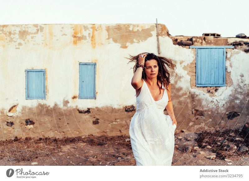 Woman in white dress walking out old house woman ancient light amazing female summer blue vacation window fashion holiday clothing tourist village tanned travel