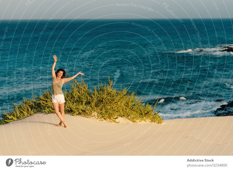 Active woman in white shorts walking sandy beach seaside turquoise ocean water female summer young tropical vacation adult beautiful healthy relax travel