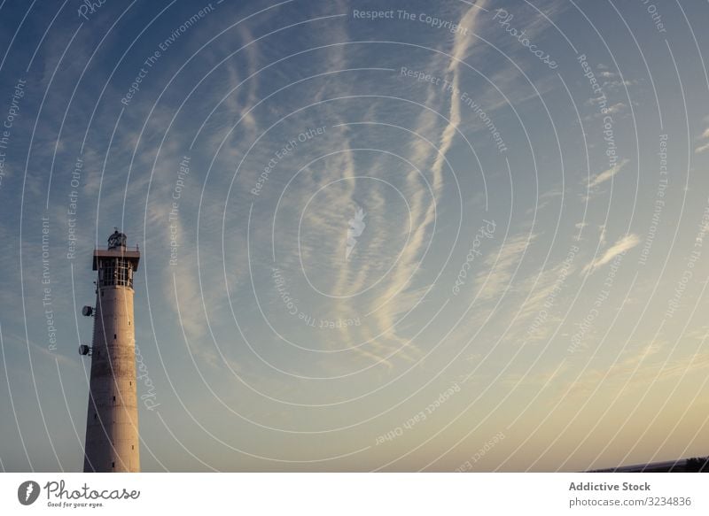 Round grey lighthouse tower rising up to sky round ocean nature architecture nautical beach breathtaking cloud travel tide las palmas fuerteventura spain