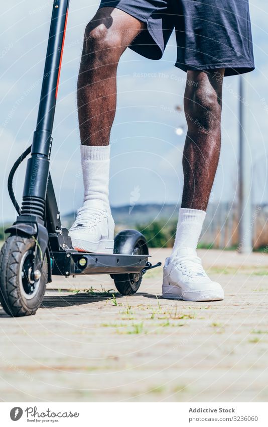 Black man riding on electric scooter in park modern black balance wheel african american movement transportation city trendy body asphalt urban entertainment