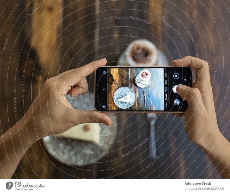 Faceless person taking picture of cake and coffee table smartphone photo cup sweet cafe dessert delicious beverage piece eat tasty leisure wooden drink mobile