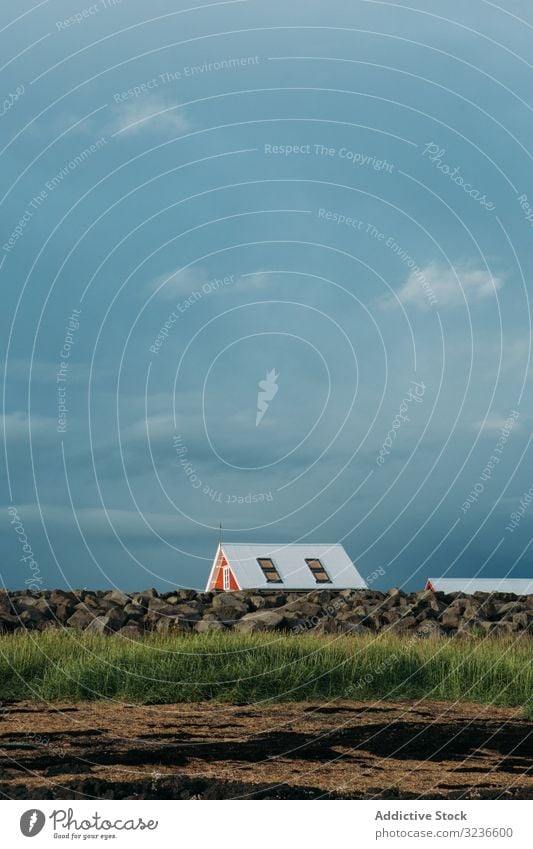 Small house in green filed under cloudy sky field landscape nature grass rural farm countryside scenery meadow hill agriculture idyllic iceland farmhouse