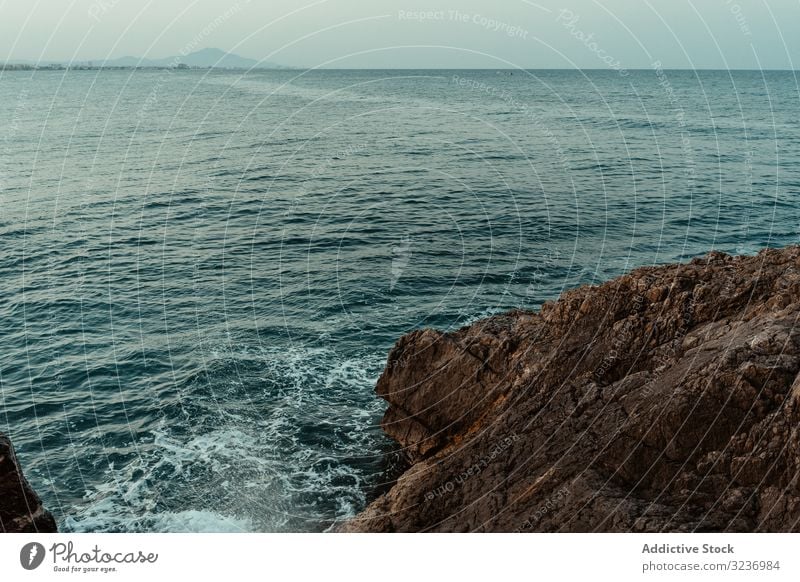 Sea waves hitting rocky cliff sea coast stone water foam splash seashore ocean nature seascape coastline landscape beach weather scenic dark power spray crash