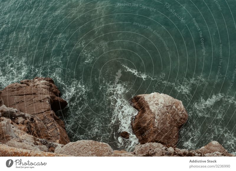 Sea waves hitting rocky cliff sea coast stone water foam splash seashore ocean nature seascape coastline landscape beach weather scenic dark power spray crash