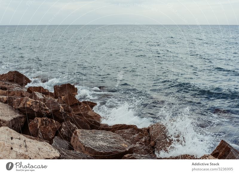 Sea waves hitting rocky cliff sea coast stone water foam splash seashore ocean nature seascape coastline landscape beach weather scenic dark power spray crash