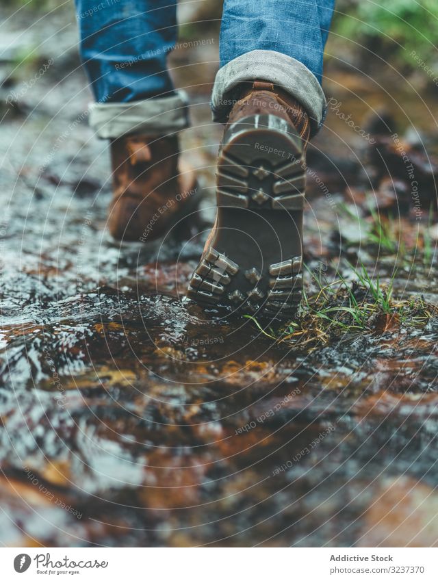 Man walking on wet autumn trail man boots footprint forest travel activity hike adventure nature male healthy exploration recreation footpath trekking legs