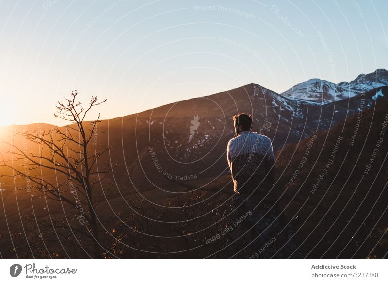 Female traveler sitting on mountain slope at sunset man autumn top relaxation enjoy peaceful thoughtful freedom sky dream beautiful alone sportive active