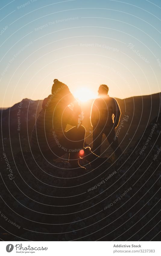 Man and woman enjoying sunset in autumn mountains top sit relaxation together peaceful thoughtful freedom sky people dream beautiful outdoors travel active