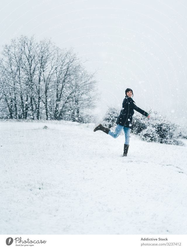 Woman playing with snow on winter field woman relaxation enjoy country forest recreation alone meadow hill tree frozen quiet jumping calm tranquil cold nature