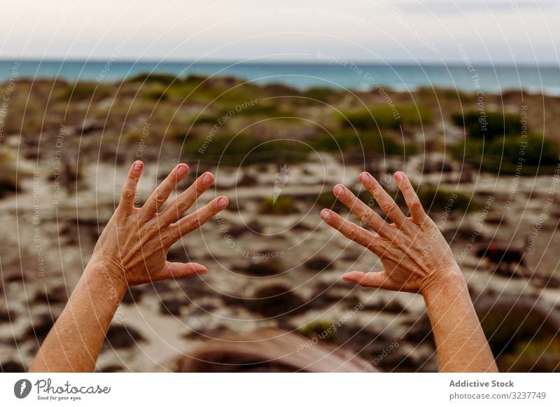 Crop person gesturing hands in nature gesture exercise tai chi meditation sky cloudy training adult healthy fit yoga zhineng qigong martial fitness workout